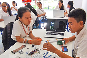 JPA Image Gallery - High school students examining IT components - Jay Pritzker Academy, Siem Reap, Cambodia