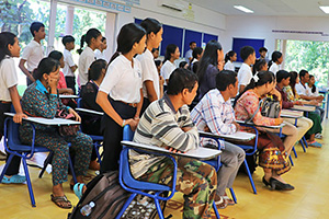 JPA Image Gallery - Students and their parents awaiting a presentation in the classroom - Jay Pritzker Academy, Siem Reap, Cambodia