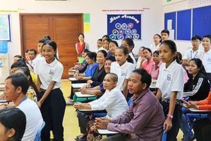 JPA Image Gallery - Students and their parents listen to a presentation - Jay Pritzker Academy, Siem Reap, Cambodia