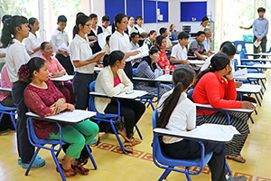 JPA Image Gallery - Parents seated at desks in classroom - Jay Pritzker Academy, Siem Reap, Cambodia