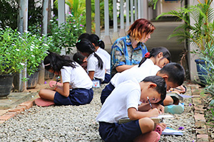 JPA Image Gallery - Primary students work on a nature assignment outside - Jay Pritzker Academy, Siem Reap, Cambodia