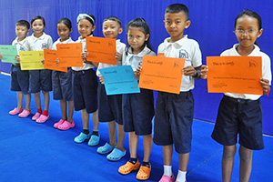 JPA Image Gallery - Primary students hold up their awards after the honors assembly - Jay Pritzker Academy, Siem Reap, Cambodia