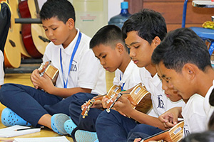 JPA Image Gallery - Students practice a song on their ukuleles - Jay Pritzker Academy, Siem Reap, Cambodia