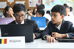 JPA Image Gallery - Two high school students at a laptop representing Belgium at the Model UN - Jay Pritzker Academy, Siem Reap, Cambodia