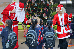 JPA Image Gallery - Mr and Mrs Claus greet kindergarten students as they arrive on campus - Jay Pritzker Academy, Siem Reap, Cambodia