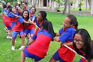JPA Image Gallery - Students laugh as they pull on their rope in a game of tug-of-war - Jay Pritzker Academy, Siem Reap, Cambodia