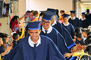 JPA Image Gallery - Graduating students walk through the corridors being cheered and congratulated by younger students - Jay Pritzker Academy, Siem Reap, Cambodia