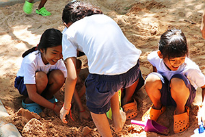 JPA Image Gallery - Primary students enjoying a sandpit - Jay Pritzker Academy, Siem Reap, Cambodia