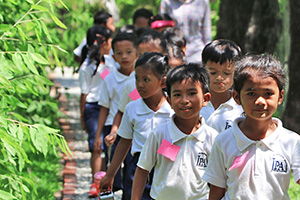 JPA Image Gallery - Primary students making their way down the footpath - Jay Pritzker Academy, Siem Reap, Cambodia