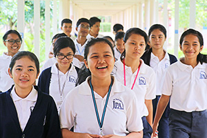 JPA Image Gallery - A group of students make their way down the outdoor corridors on campus - Jay Pritzker Academy, Siem Reap, Cambodia