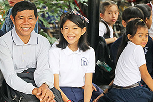 JPA Image Gallery - A student and her father smile for the camera - Jay Pritzker Academy, Siem Reap, Cambodia