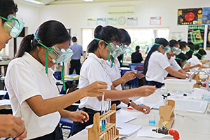 JPA Image Gallery - Chemistry students working on experiment with test tubes - Jay Pritzker Academy, Siem Reap, Cambodia