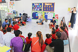 JPA Image Gallery - Parents and preschool students sitting on the floor in a circle in classroom - Jay Pritzker Academy, Siem Reap, Cambodia