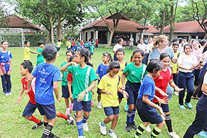 JPA Image Gallery - Students wearing JPA values t-shirts outside at activity for Khmer New Year - Jay Pritzker Academy, Siem Reap, Cambodia