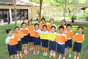 JPA Image Gallery - Primary students smiling holding Honor Roll certificates - Jay Pritzker Academy, Siem Reap, Cambodia