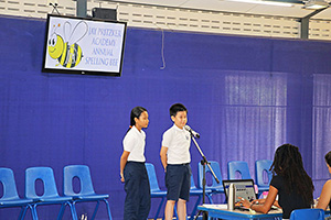 JPA Image Gallery - 2 students on stage participating in annual spelling bee - Jay Pritzker Academy, Siem Reap, Cambodia