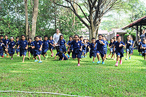 JPA Image Gallery - Kindergarten students running a race field - Jay Pritzker Academy, Siem Reap, Cambodia