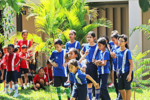 JPA Image Gallery - Students in JPA values shirts take part in a game outdoors - Jay Pritzker Academy, Siem Reap, Cambodia