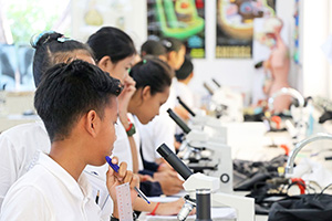 JPA Image Gallery - Students in science lab using microscopes - Jay Pritzker Academy, Siem Reap, Cambodia