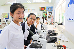 JPA Image Gallery - Students working on class activity with microscopes - Jay Pritzker Academy, Siem Reap, Cambodia