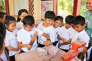 JPA Image Gallery - Grade 3 students have a go at carving stone at artisans workshop - Jay Pritzker Academy, Siem Reap, Cambodia