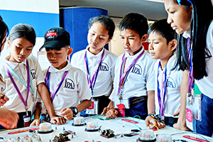 JPA Image Gallery - A group of students check out a science exhibit in Phnom Penh - Jay Pritzker Academy, Siem Reap, Cambodia