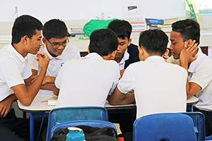 JPA Image Gallery - A group of high school students work together on a group assignment - Jay Pritzker Academy, Siem Reap, Cambodia