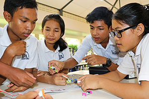 JPA Image Gallery - High school students work together to identify the different components of an electronic model - Jay Pritzker Academy, Siem Reap, Cambodia