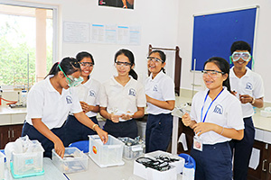 JPA Image Gallery - High school students putting on protective eyewear before class experiment - Jay Pritzker Academy, Siem Reap, Cambodia
