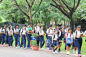 JPA Image Gallery - Students arriving on campus with books and bookbags - Jay Pritzker Academy, Siem Reap, Cambodia