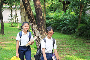 JPA Image Gallery - 2 students arriving at school in the morning with their books - Jay Pritzker Academy, Siem Reap, Cambodia
