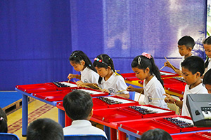 JPA Image Gallery - Primary students playing musical instruments at assembly - Jay Pritzker Academy, Siem Reap, Cambodia