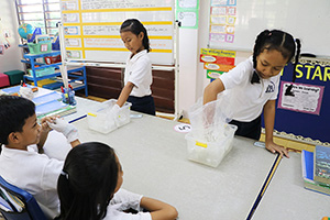 JPA Image Gallery - Primary students doing an experiment in class - Jay Pritzker Academy, Siem Reap, Cambodia