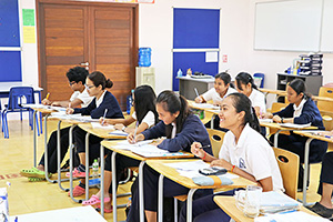 JPA Image Gallery - High school students at desks taking notes in class - Jay Pritzker Academy, Siem Reap, Cambodia