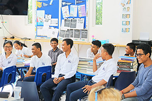 JPA Image Gallery - High school students with their books sharing a laugh - Jay Pritzker Academy, Siem Reap, Cambodia