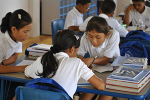 JPA Image Gallery - Students work through an assignment at tables - Jay Pritzker Academy, Siem Reap, Cambodia