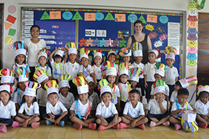 JPA Image Gallery - Primary students gather for a class photo with their hand-made hats - Jay Pritzker Academy, Siem Reap, Cambodia