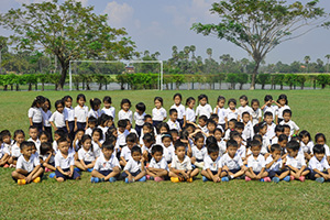 JPA Image Gallery - Primary students gather on the soccer field for a group photo - Jay Pritzker Academy, Siem Reap, Cambodia