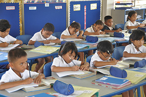 JPA Image Gallery - Primary students work at an assignment at their desks - Jay Pritzker Academy, Siem Reap, Cambodia