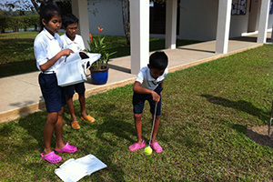 JPA Image Gallery - Primary students work through an experiment outdoors - Jay Pritzker Academy, Siem Reap, Cambodia