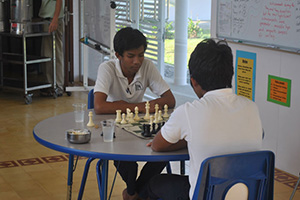 JPA Image Gallery - Two high school students enjoy a game of chess - Jay Pritzker Academy, Siem Reap, Cambodia