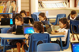 JPA Image Gallery - Primary students work on laptops in the library - Jay Pritzker Academy, Siem Reap, Cambodia