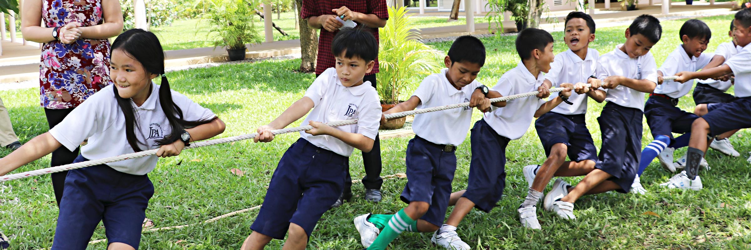 Jay Pritzker Academy, Siem Reap, Cambodia. JPA students playing tug-of-war during Khmer Pchum Ben celebrations at the JPA campus. Jay-Pritzker-Academy-Siem-Reap-Cambodia.